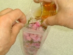 写真：サクラの花にウメ酢を注ぎ入れる
