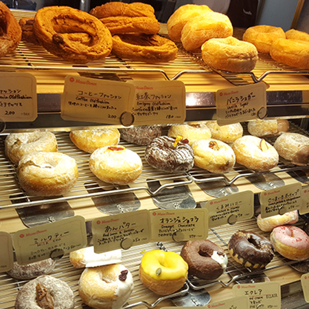 Donuts lined up on a display stand